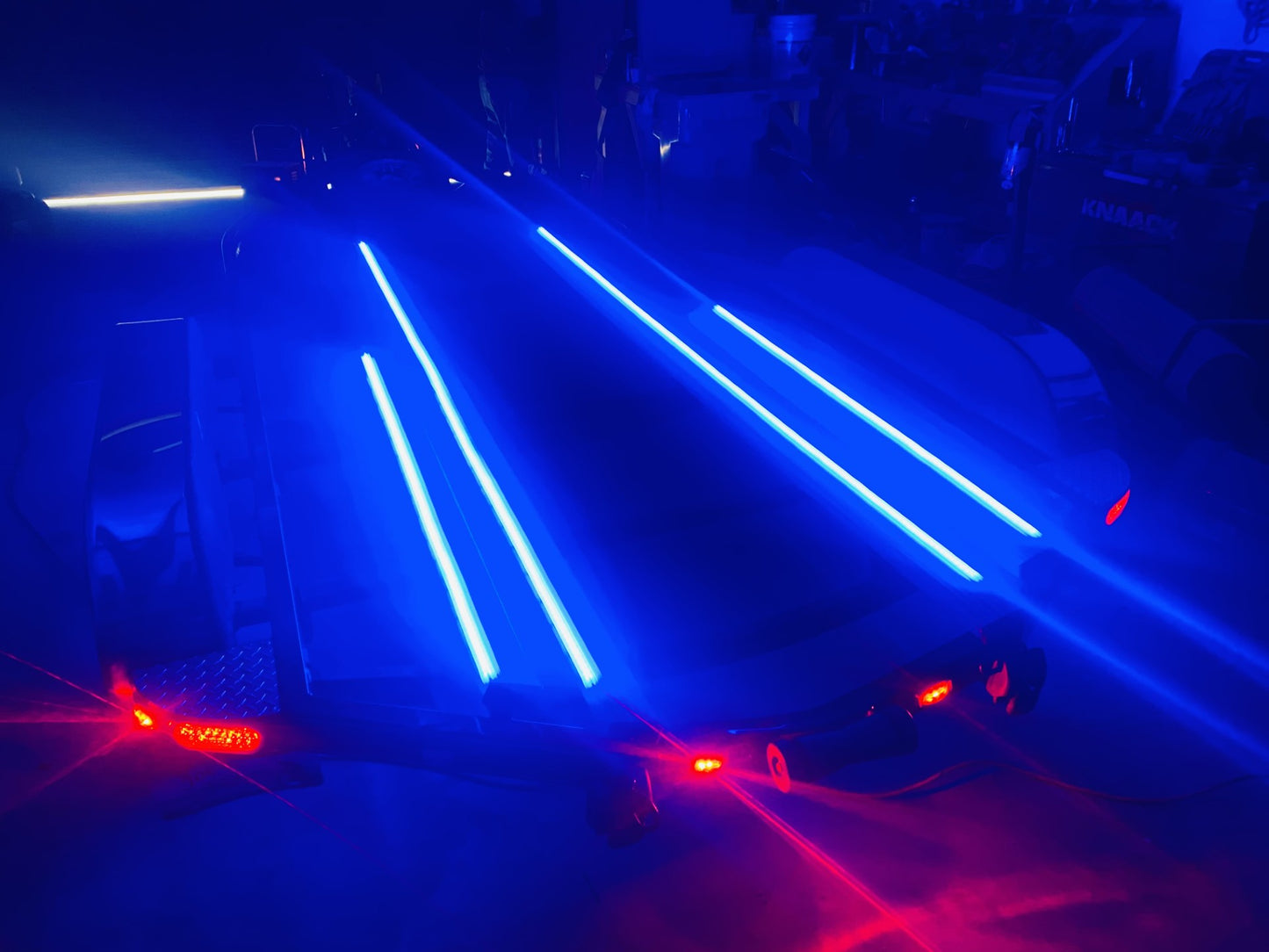 Blue String LED Plashlights on Synthetic Bunks mounted to Fiberglass boat trailer illuminated in the dark