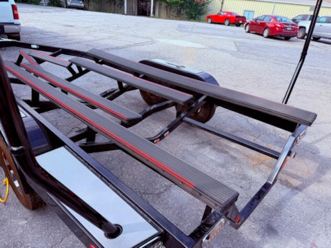 Boat trailer bunk maintenance inspection at the boat ramp