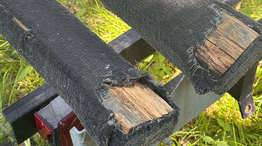Worn pontoon trailer bunk carpet ready for replacement